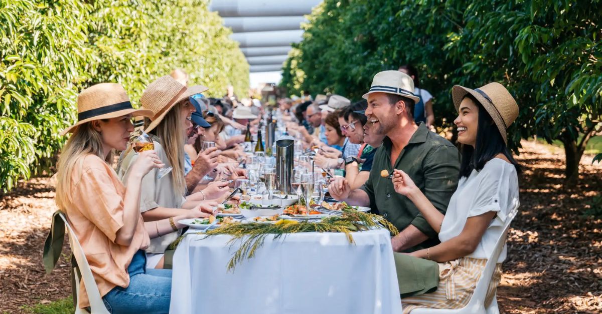 table of people enjoying food outdoors at the curated plate 2026